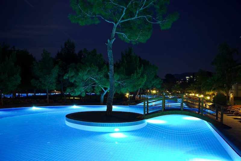 Illuminated swimming pool and bridges at night