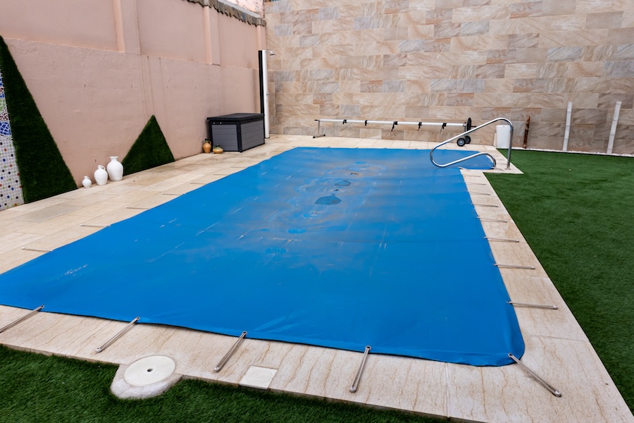 A pool cover stretched tight over a pool