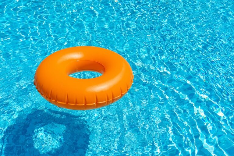 Orange ring floating in a refreshing blue swimming pool