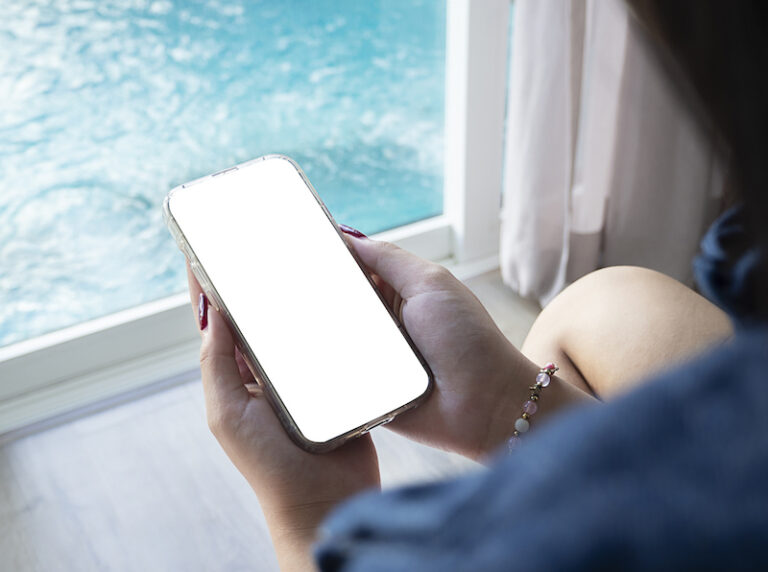 woman using smart phone to do her pool automation