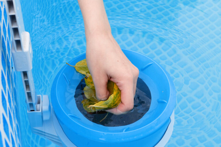 girl cleans skimmer for the frame pool. Contaminated pool cleaning concept