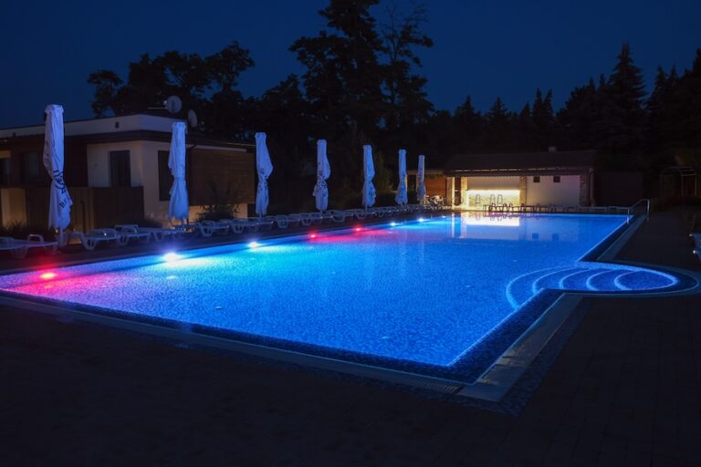 Summer outdoor pool with lighting at night.