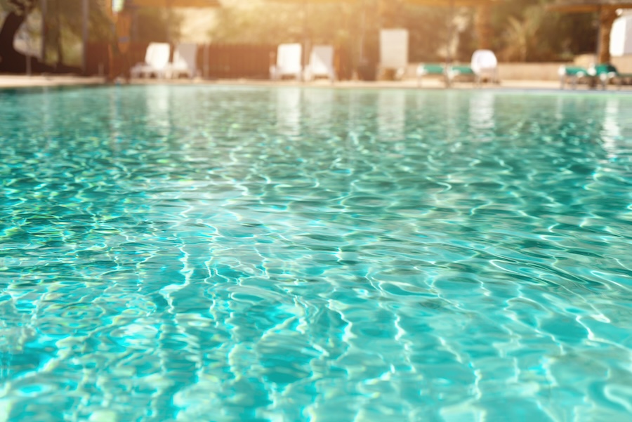 Closeup of light blue, sparkling pool water