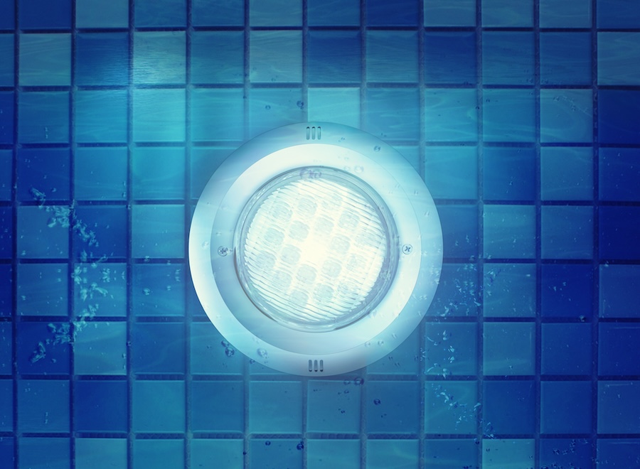 Night scene photo of pool light under water.