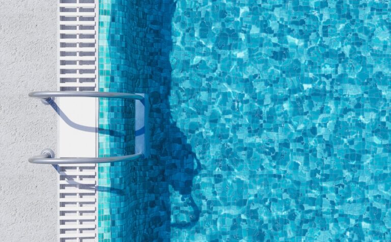 top view of a swimming pool with metal ladders