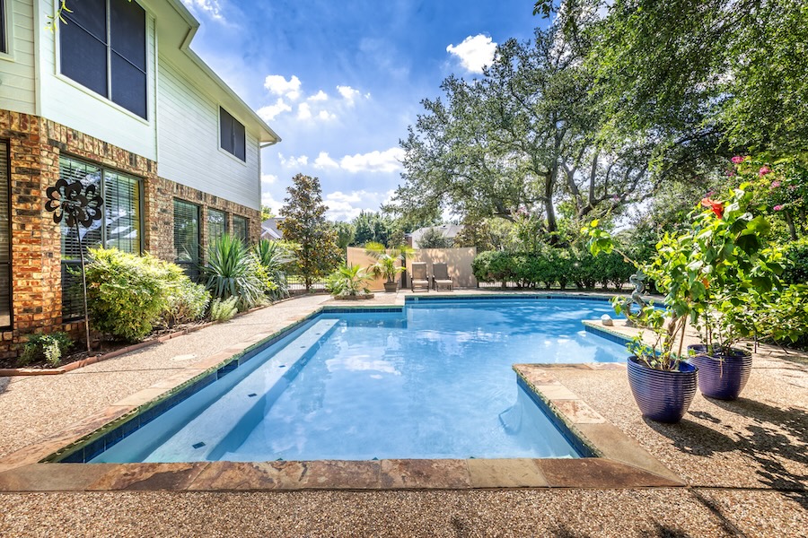 Backyard oasis with a swimming pool inside a private residential backyard