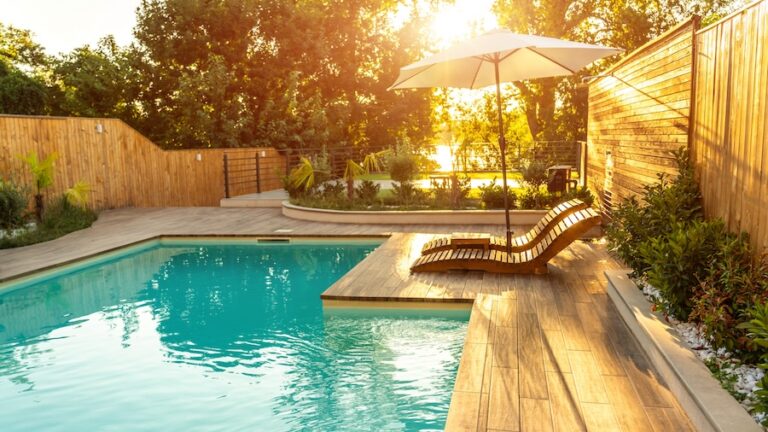 Swimming pool in modern private villa with lounge chairs