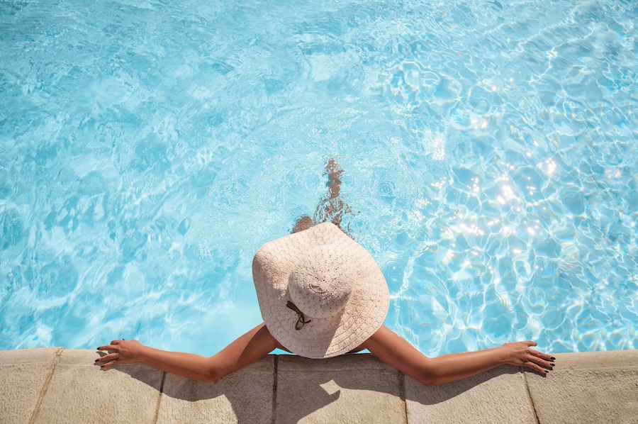 Young woman relaxing in the swimming pool