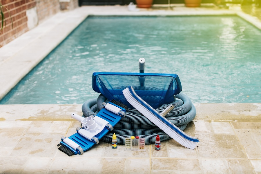 Image of pool cleaning and maintenance kit, vacuum cleaner, ph test, leaf picker and pool sweeper