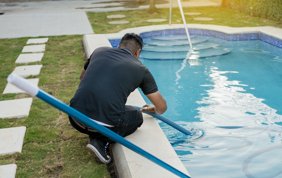 maintenance-person-cleaning-swimming-pool-with-suction-hose-cleaning-and-maintenance-of-swimming-pools-with-suction-hose-crouched-man-cleaning-swimming-pool-with-vacuum-hose-2