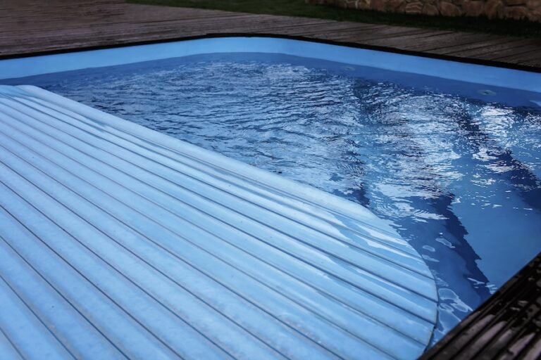 Automatic swimming pool covering system, safely protect children and pets from accidental contact with water, home and cottage equipment, copyspace, place for text, outdoor exterior