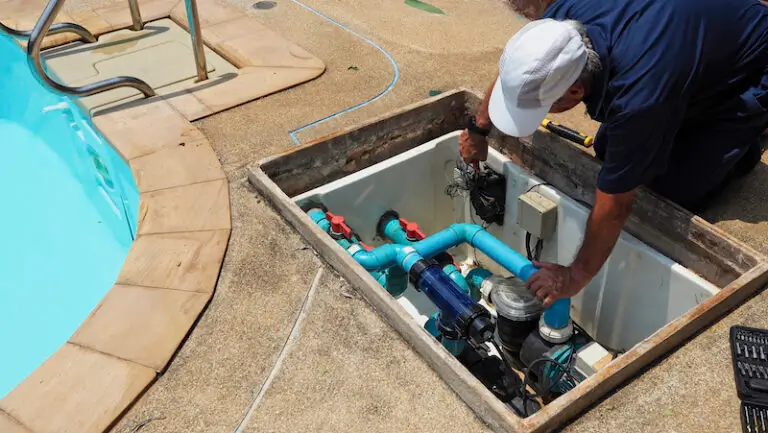 Technician fixing swimming pool water heater pump. Service and maintenance for swimming pool.