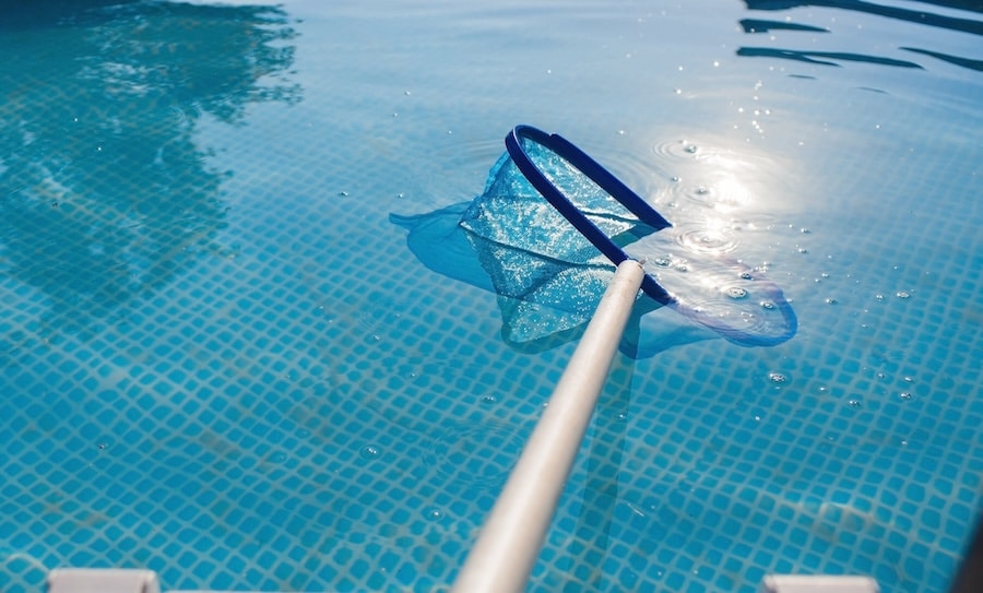 abstract-blur-and-defocused-background-cleaning-of-a-swimming-pool-with-a-metal-frame-with-a-mesh-from-dirt-pool-cleaner-during-operation-solar-banner-the-concept-of-summer-holidays-3